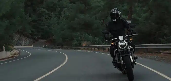 man riding motorcycle on concrete street